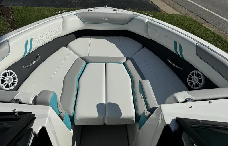 Slide: The Image of 2025 Regal LS2 boat interior with white and teal seating, speakers, and modern design. - 10