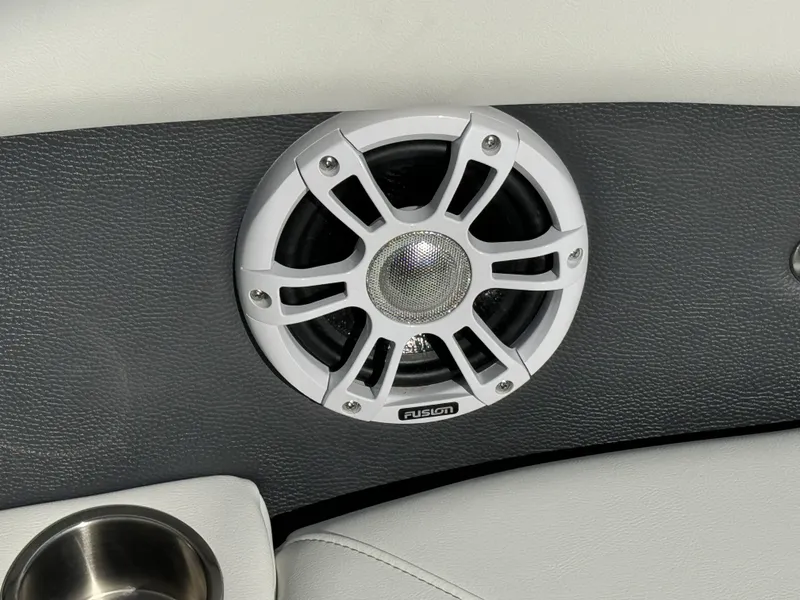Slide: The Image of Speaker on 2025 Regal LS2 boat interior with white and gray upholstery. - 14