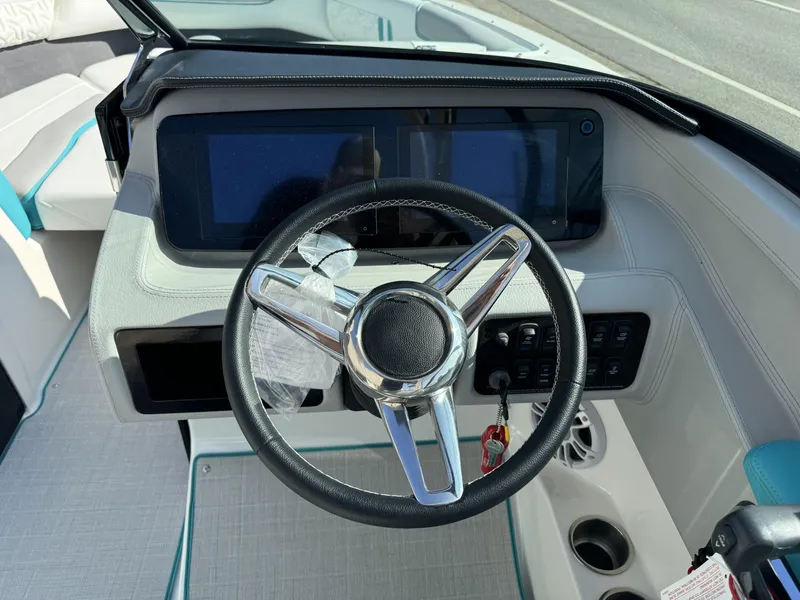 Slide: The Image of 2025 Regal LS2 boat dashboard with steering wheel and digital display. - 5