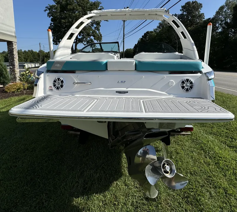 Slide: The Image of 2025 Regal LS2 boat rear view with swim platform and propeller on grass. - 7