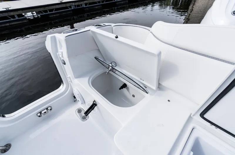 Slide: The Image of 2025 Sea Hunt Ultra 275 SE boat interior with open storage compartment. - 19