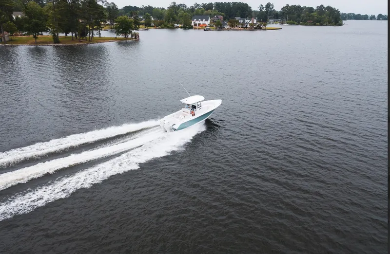 Slide: The Image of 2025 Sea Hunt Ultra 275 SE cruising on a serene lake. - 28