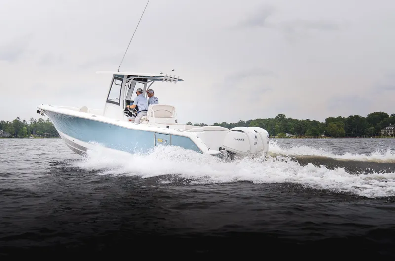 Slide: The Image of 2025 Sea Hunt Ultra 275 SE boat cruising on a lake with two passengers. - 33