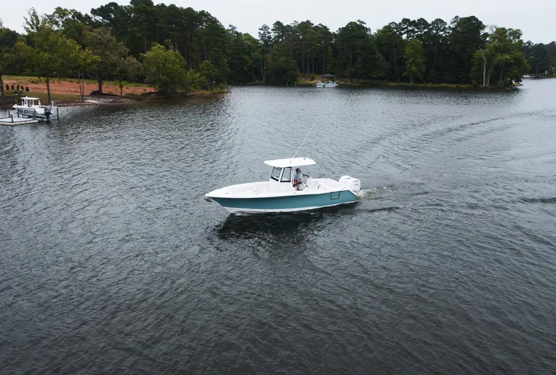 Slide: The Image of 2025 Sea Hunt Ultra 275 SE boat cruising on a serene lake. - 36