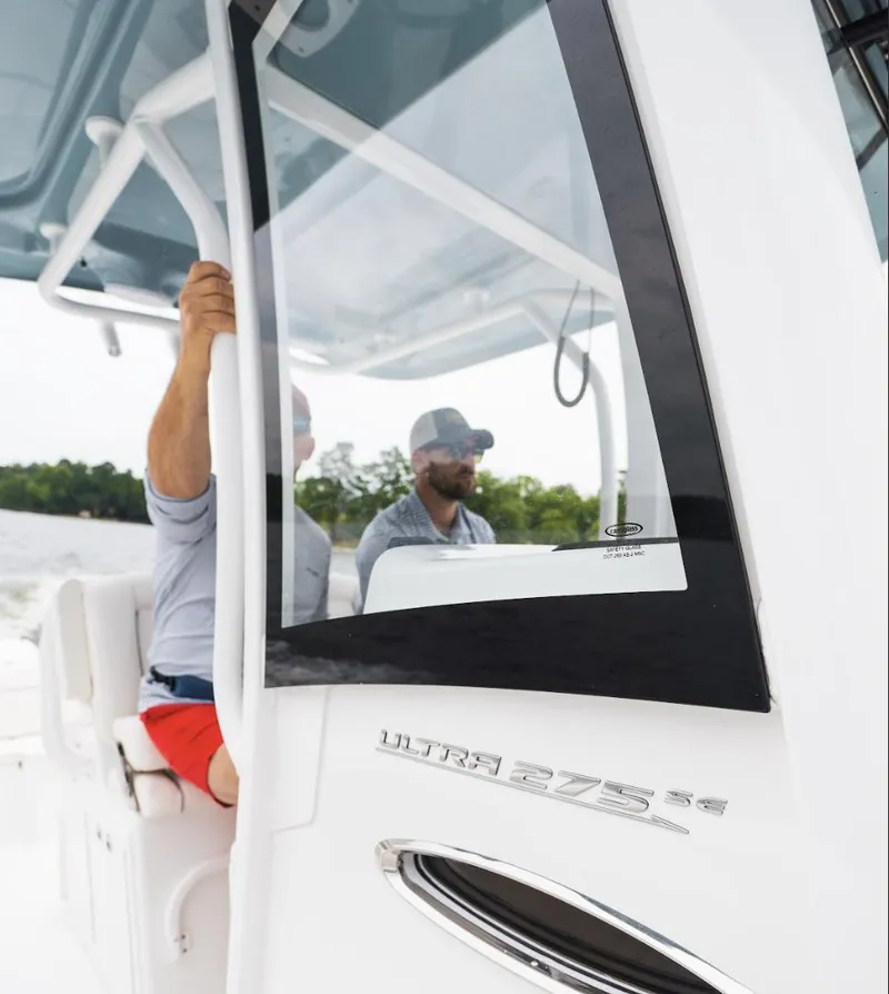 Slide: The Image of 2025 Sea Hunt Ultra 275 SE boat with two people onboard, navigating through water. - 38