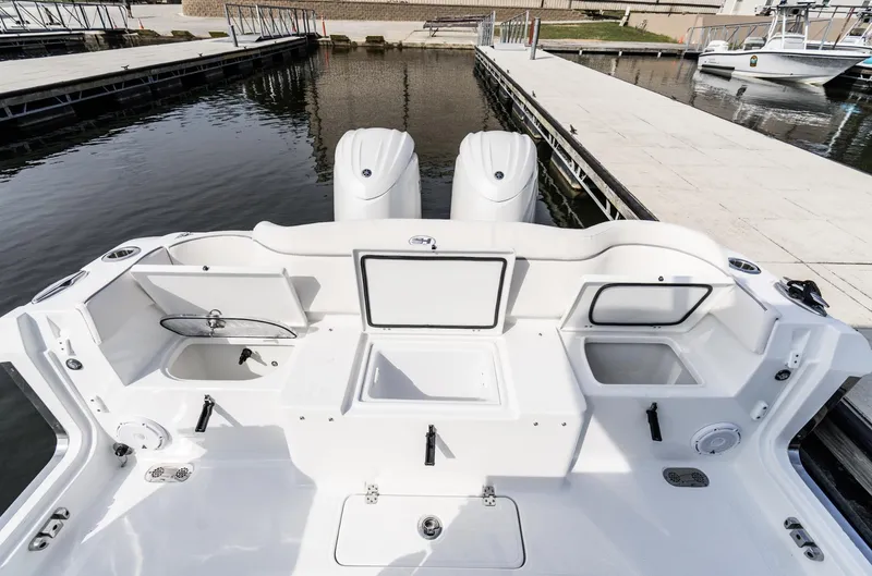 Slide: The Image of 2025 Sea Hunt Ultra 275 SE boat interior with dual engines at dock. - 41