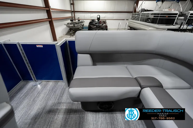 Slide: The Image of 2025 Bennington 168SF boat interior with gray seating in showroom. - 15