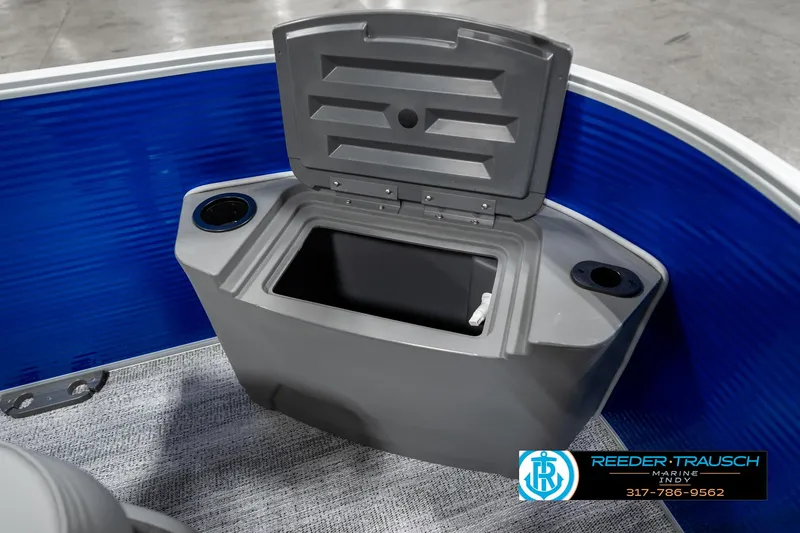 Slide: The Image of Bennington 168SF 2025 boat storage compartment with cup holders, blue interior. - 21