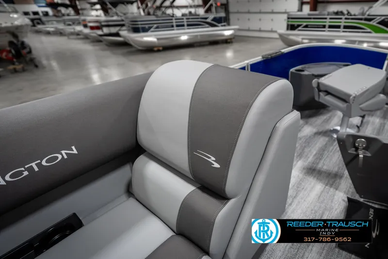 Slide: The Image of 2025 Bennington 168SF boat interior with gray seating in showroom. - 27