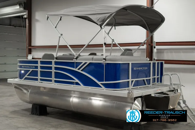Slide: The Image of 2025 Bennington 168SF pontoon boat with canopy in indoor showroom. - 6