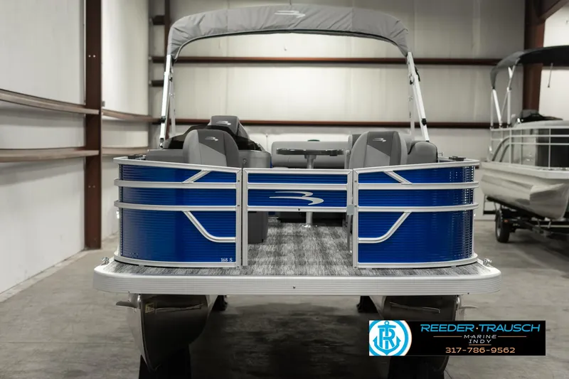 Slide: The Image of 2025 Bennington 168SF pontoon boat in a showroom, featuring blue exterior and gray seating. - 8
