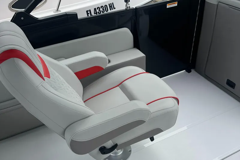 Slide: The Image of Captain's chair on 2025 Hurricane FunDeck 2360 SFL OB boat, featuring sleek design and red accents. - 12
