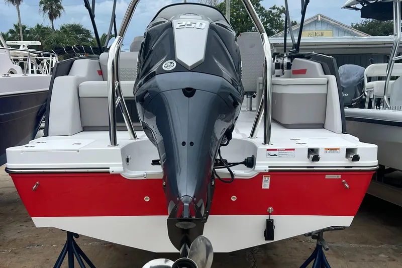 Slide: The Image of 2025 Hurricane FunDeck 2360 SFL OB boat with powerful outboard motor, red and white design. - 2