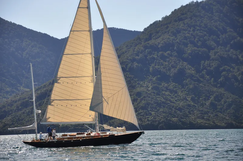 Slide: The Image of Sailing yacht Sparkman & Stephens S&S 45, 2010, gliding on serene waters with mountainous backdrop. - 13