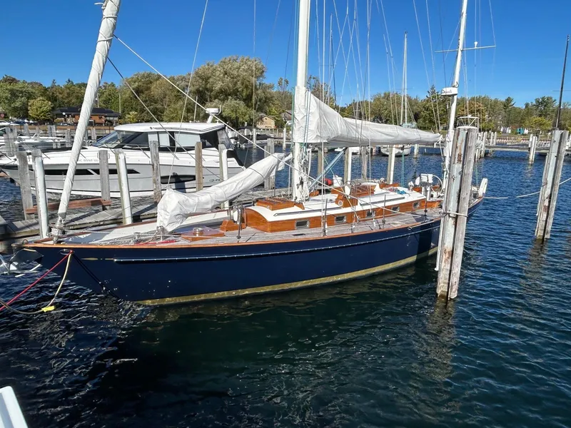 Slide: The Image of Sailboat docked in marina, Sparkman & Stephens S&S 45, 2010 model, with blue hull and white sails. - 29
