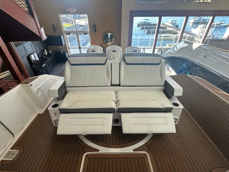 Slide: The Image of 2022 Tiara Yachts 43 LE interior with luxurious seating and marina view. - 11