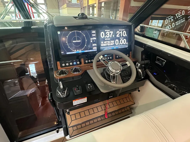 Slide: The Image of 2022 Tiara Yachts 43 LE helm with advanced navigation display and controls. - 20