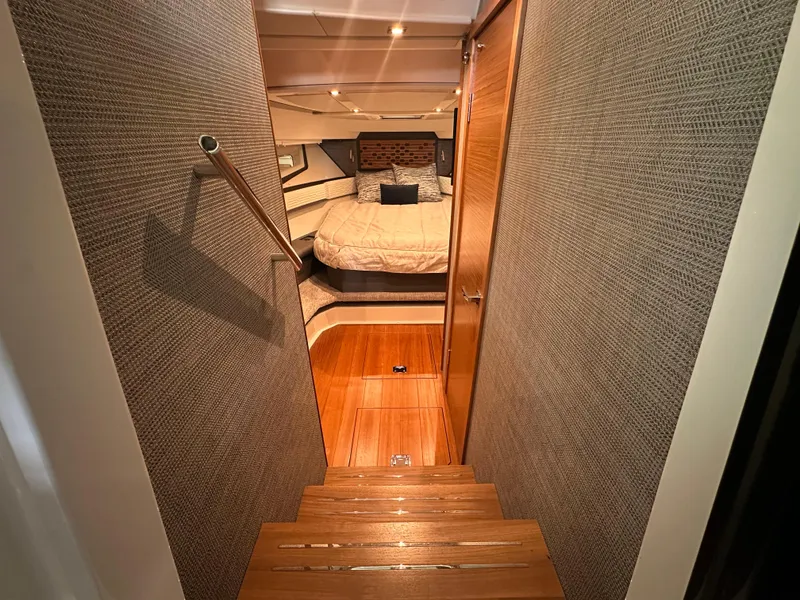 Slide: The Image of Luxurious interior of 2022 Tiara Yachts 43 LE, featuring cozy bedroom and wooden flooring. - 26