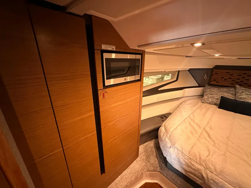 Slide: The Image of Luxurious interior of 2022 Tiara Yachts 43 LE with cozy bed and modern wood finishes. - 28