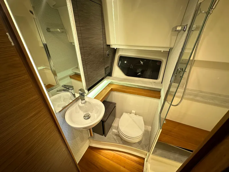 Slide: The Image of Luxurious bathroom in 2022 Tiara Yachts 43 LE, featuring modern fixtures and wood accents. - 29