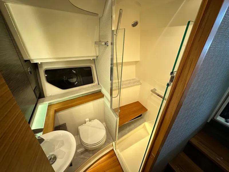 Slide: The Image of 2022 Tiara Yachts 43 LE bathroom with modern fixtures and wooden accents. - 30