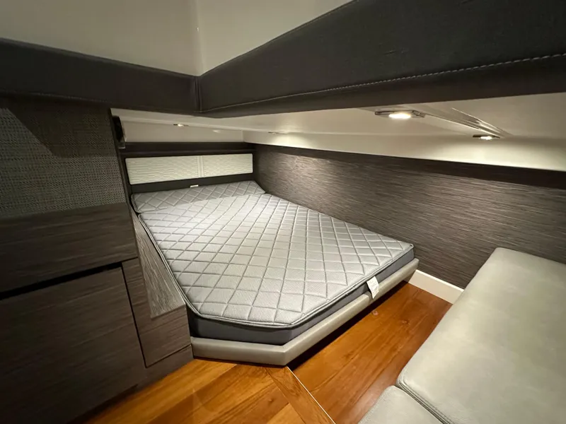 Slide: The Image of 2022 Tiara Yachts 43 LE cabin interior with modern bed and wood flooring. - 32