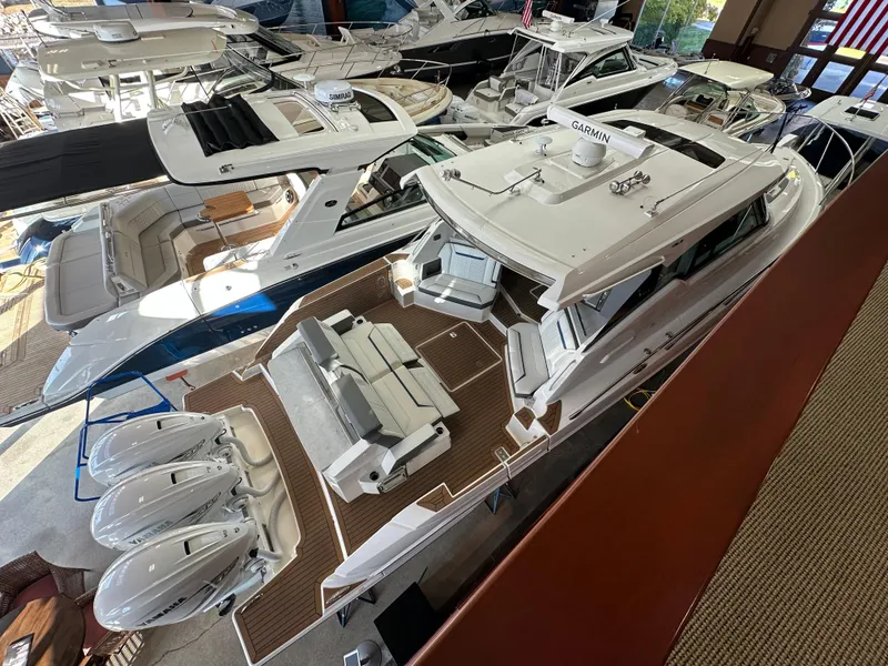 Slide: The Image of 2022 Tiara Yachts 43 LE with triple outboard engines in showroom. - 4