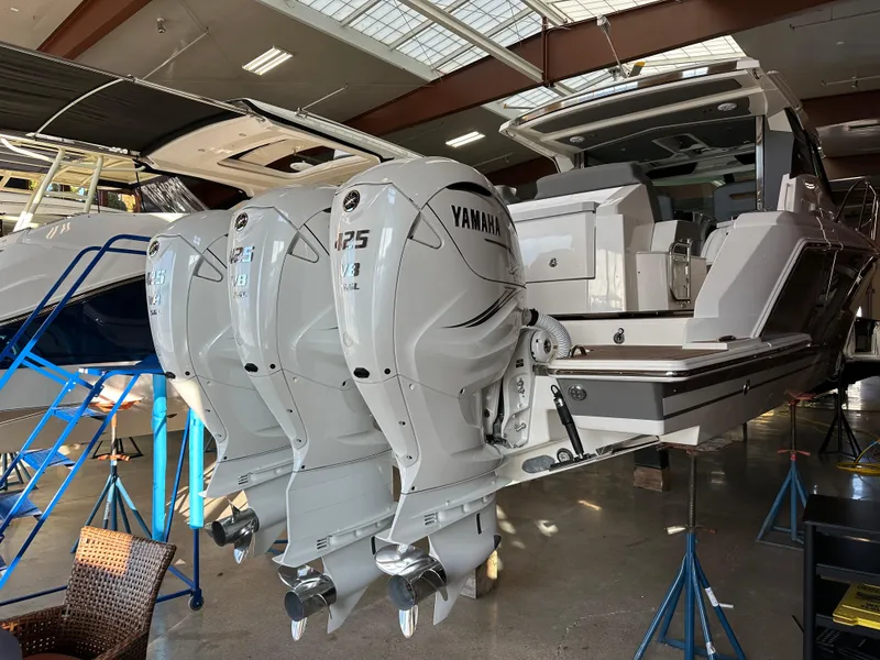 Slide: The Image of 2022 Tiara Yachts 43 LE with triple Yamaha outboard engines in a showroom. - 6