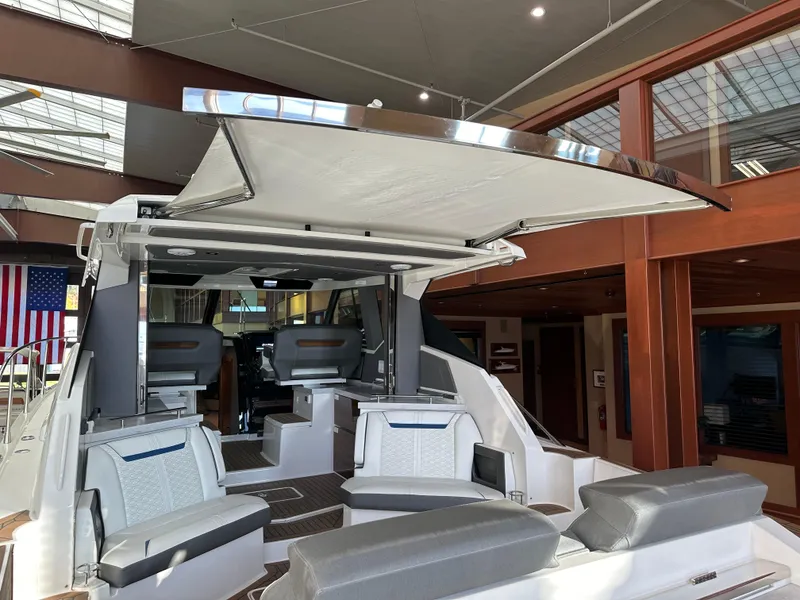 Slide: The Image of 2022 Tiara Yachts 43 LE interior with seating and retractable canopy. - 8