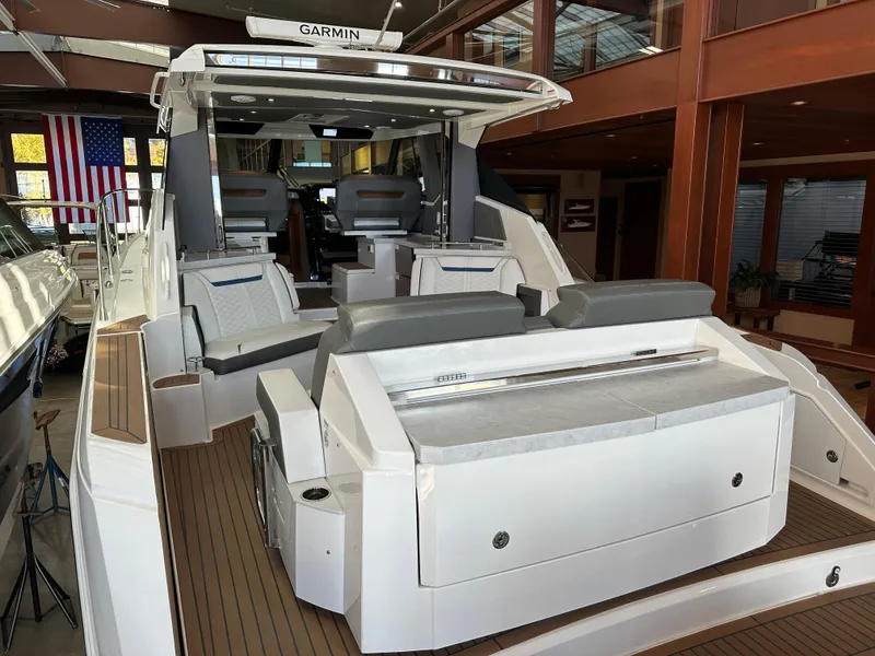 Slide: The Image of 2022 Tiara Yachts 43 LE luxury boat interior with seating and Garmin equipment. - 9