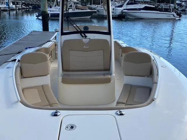 Slide: The Image of 2021 Scout 277 LXF boat interior with seating, docked at marina. - 10