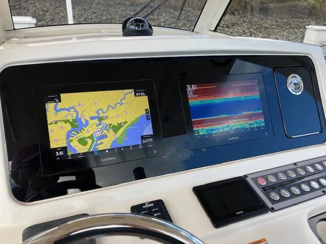 Slide: The Image of 2021 Scout 277 LXF boat dashboard with Garmin navigation displays. - 12
