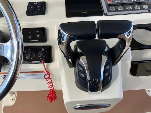 Slide: The Image of 2021 Scout 277 LXF boat controls with Yamaha throttle and steering wheel. - 15