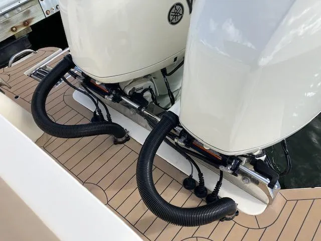 Slide: The Image of 2021 Scout 277 LXF boat with dual outboard motors and teak deck. - 18