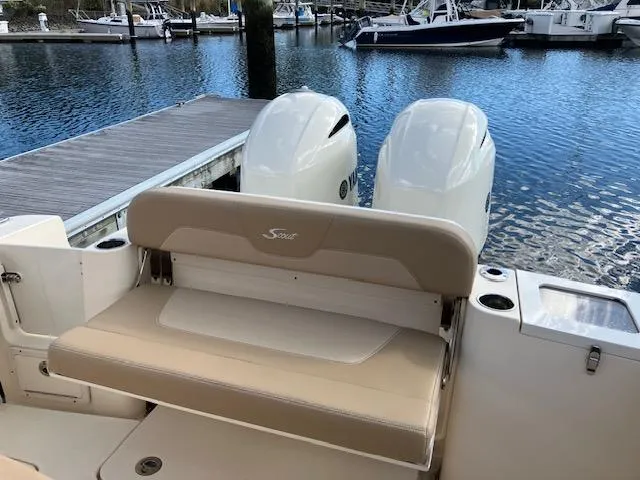 Slide: The Image of 2021 Scout 277 LXF boat with twin engines docked at marina. - 20