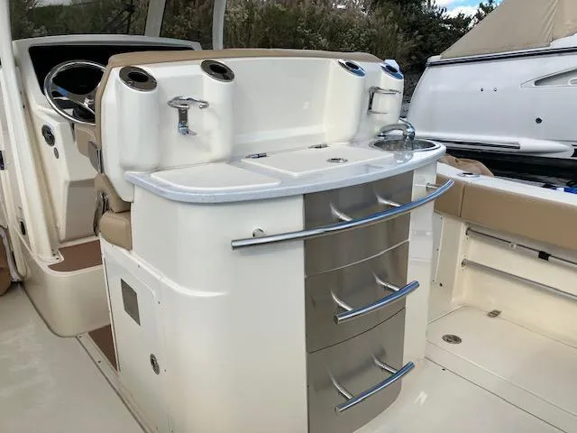 Slide: The Image of 2021 Scout 277 LXF boat interior with sleek kitchen area and storage drawers. - 22