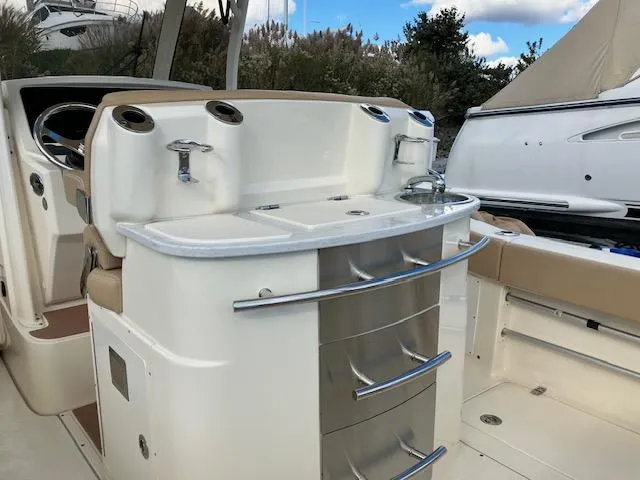 Slide: The Image of 2021 Scout 277 LXF boat interior with sleek storage and seating. - 24