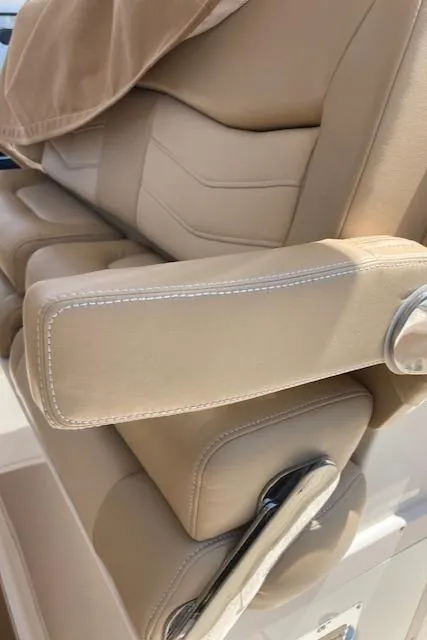 Slide: The Image of 2021 Scout 277 LXF boat seat with beige upholstery and armrest detail. - 27