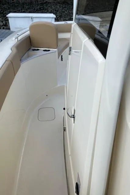 Slide: The Image of 2021 Scout 277 LXF boat interior with beige seating and sleek design. - 30