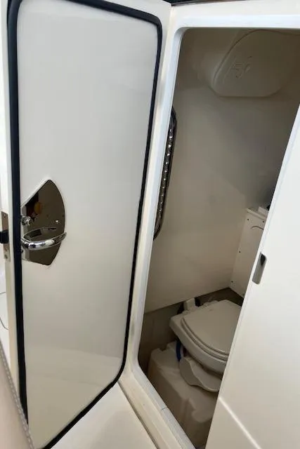 Slide: The Image of 2021 Scout 277 LXF boat interior bathroom with open door. - 31