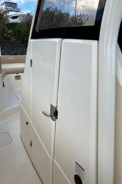 Slide: The Image of 2021 Scout 277 LXF boat cabin door with sleek design and modern finish. - 32