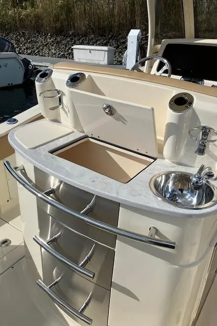 Slide: The Image of 2021 Scout 277 LXF boat interior with sink and storage compartments. - 37