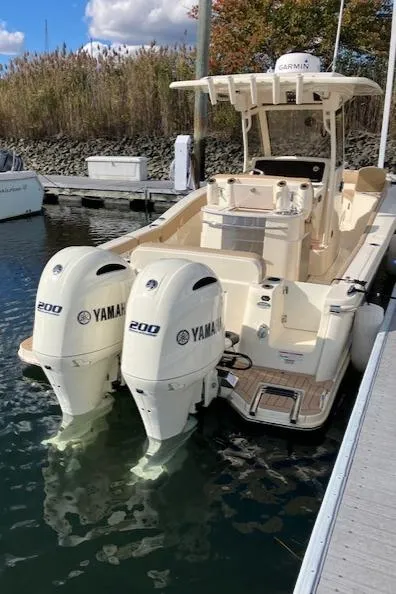Slide: The Image of 2021 Scout 277 LXF boat with twin Yamaha 200 engines docked in marina. - 38