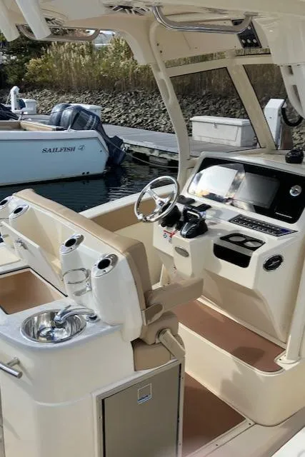 Slide: The Image of 2021 Scout 277 LXF boat interior with modern helm and seating. - 39
