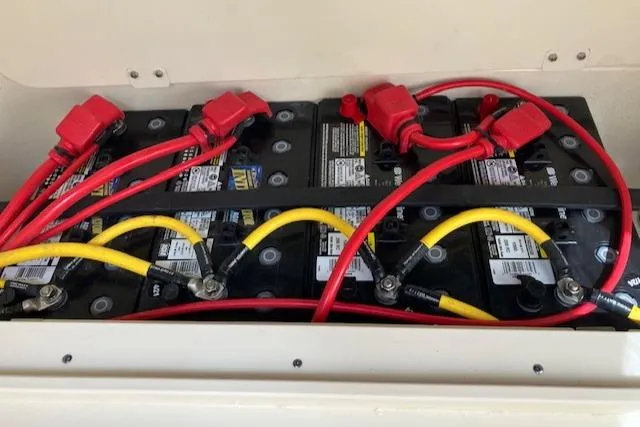Slide: The Image of 2021 Scout 277 LXF boat battery compartment with red and yellow cables. - 42