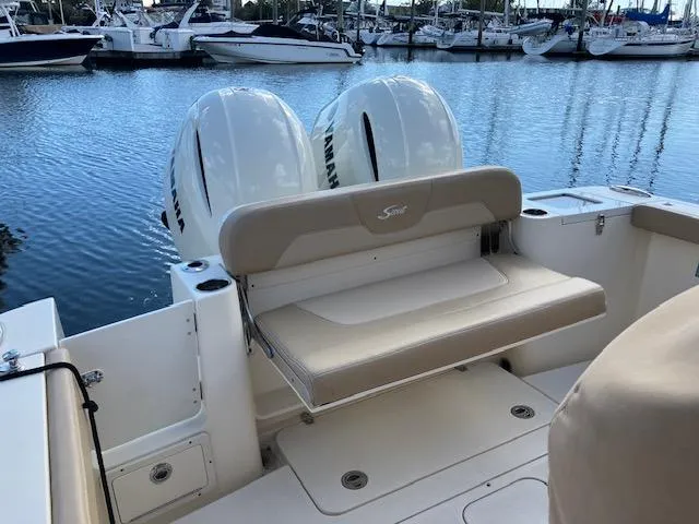 Slide: The Image of 2021 Scout 277 LXF boat with twin Yamaha engines at marina. - 8