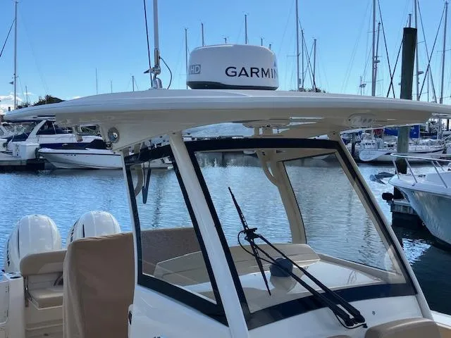 Slide: The Image of 2021 Scout 277 LXF boat with Garmin radar, docked in a marina. - 9
