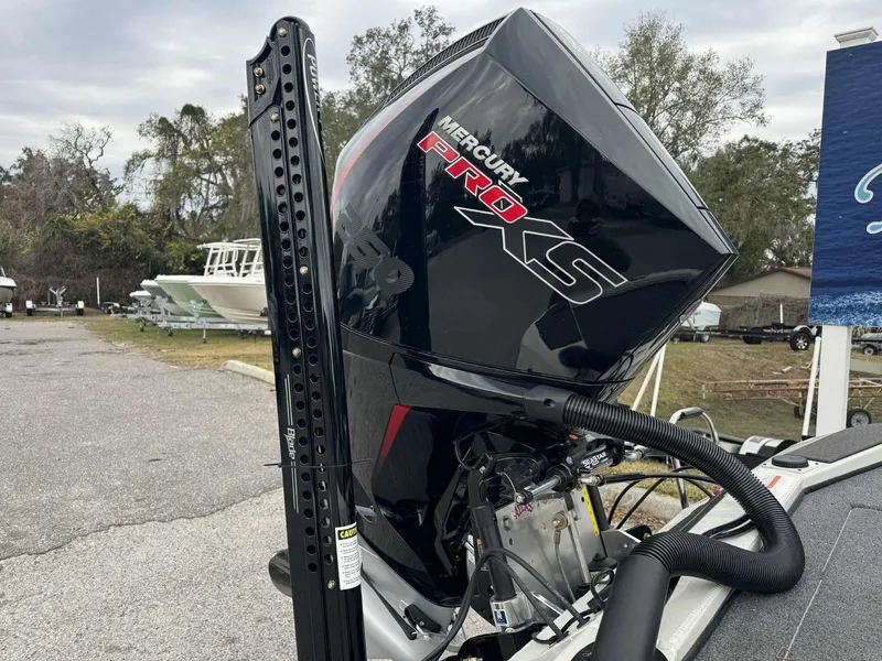 Slide: The Image of 2025 Ranger ALPHA 208 with Mercury Pro XS outboard motor in a boatyard. - 14