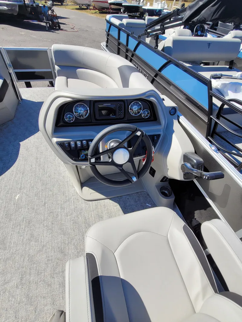 Slide: The Image of 2025 Trifecta 22TRFCLE275 boat interior with steering wheel and dashboard controls. - 10