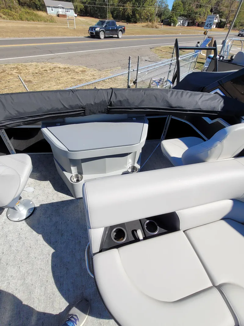 Slide: The Image of 2025 Trifecta 22TRFCLE275 pontoon boat interior with seating and table. - 12